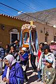 Parishioners carry a statue of the Virgin in a religious procession in the town of Tilcara, Argentina.