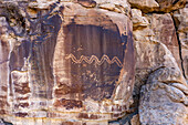 Aerial drone view of a pre-Hispanic Amerindian rock art petropglyph panel of the Fremont Culture in Nine Mile Canyon, Utah. A large snake is depicted on this panel.