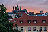 View of city skyline and Prague Castle (Pražský hrad) at sunset from Charles Bridge in Prague