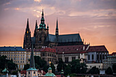 View of city skyline and Prague Castle (Pražský hrad) at sunset from Charles Bridge in Prague