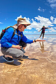 Tourists posing for humorous pictures on the salt flats of Salinas Grandes in northwest Argentina.