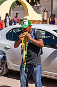 An indigenous man plays the siku panpipes plays for a religious procession in front of the church in Tilcara, Argentina.