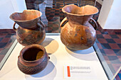 Pre-Hispanic ceramic jars for preparing and storing chicha in the Dr. Eduardo Casanova Archeology Museum in Tilcara, Argentina.