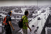 Visitors in front of a photo did shoot before atomic bomb blast in Nagasaki of Aioi bridge. Exhibition inside the Hiroshima Peace Memorial Museum, Hiroshima, Japan