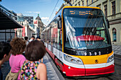 People waiting for the tram in Prague