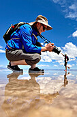 Tourists posing for humorous pictures on the salt flats of Salinas Grandes in northwest Argentina.