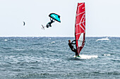 Participants compete in the World Windsurfing Championship at El Medano, Tenerife, Spain. Experience thrilling action and dynamic performances on the sea in August 2024.