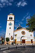 The exterior of the Church of Our Lady of the Rosary with its single bell tower with a clock. Monteros, Argentina.