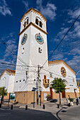 The exterior of the Church of Our Lady of the Rosary with its single bell tower with a clock. Monteros, Argentina.