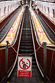 People using Prague Metro electric stairs