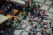 View of tourists, shops and restaurants from the tower of the Old Town Hall in Prague