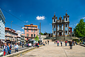 Porto, Portugal, Apr 15 2017, Scenic view of Santo Ildefonso Church in Porto, Portugal, capturing lively street scenes and historic architecture under a clear blue sky.