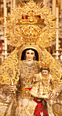 Carrion, Spain, Sep 28 2010, The statue of the Virgin Mary, crowned in gold and holding a child, is showcased on an ornate altar adorned with candles.