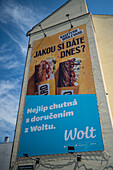 Wolt ad on building wall in Prague