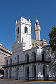 Cabildo with the clock tower of the Legislative Palace of the Autonomous City of Buenos Aires, Argentina behind. The Cabildo was the town hall or seat of government in colonial times.