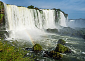 A rainbow in front of the Floriano Waterfall at Iguazu Falls National Park in Brazil. A UNESCO World Heritage Site.