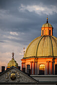 View of St. Francis of Assisi Church and city skyline at sunset from Charles Bridge in Prague