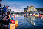 Wpman float lanterns on the river, in front of Atomic Bomb Dome with floating lamps on Motoyasu-gawa River during Peace Memorial Ceremony every August 6 in Hiroshima, Japan