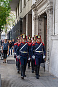 The military honor guard marching from the tomb of San Martin in the Cathedral to the Casa Rosada in Buenos Aires, Argentina. The soldiers are members of the Ayacucho Squadron of the Regiment of Horse Grenadiers.