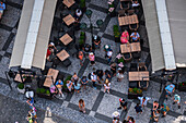 View of tourists, shops and restaurants from the tower of the Old Town Hall in Prague