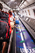 People using Prague Metro electric stairs