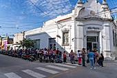 Customers wait in a long line outside a bank in Monteros, Tucumán Province, Argentina.