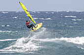 Exciting moment captured during the Windsurfing World Championship in El Medano, Tenerife, Spain, featuring athletes and ocean waves in August 2024.