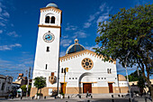 The exterior of the Church of Our Lady of the Rosary with its single bell tower with a clock. Monteros, Argentina.