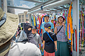 Children doing a offering and taking a picture, in Peace Monument of Children, Peace Park, Hiroshima, Japan