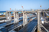 A vehicle loading dock of Fred Olsen shipping company at Los Cristianos port, Tenerife, Canary Islands, Spain. Clear blue skies and transportation infrastructure.