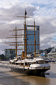 The ARA Uruguay, a museum ship in Puerto Madero in Buenos Aires, Argentina. Behind is the ICBN Bank Building.