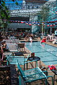 Clients refresh by the pool at Manifesto Market, a must-visit cultural experience in the heart of Prague with pop-up design retail experience bars and high-quality street food.