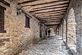 Yanguas, Spain, Aug 14 2009, Visitors stroll through the charming arcade of Plaza Mayor, surrounded by timeless stone architecture in Yanguas, Soria, Spain.