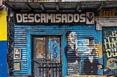 A street art mural painted around a weather door in a building in Caminito, La Boca, Buenos Aires, Argentina.