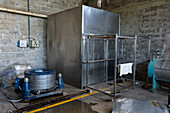 A centrifugal dryer for spinning excess water out of the washed wool & oven dryer. Hilandería Warmi, a weaving mill in Palpalá, Argentina.