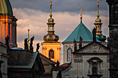 View of city skyline at sunset from Charles Bridge in Prague