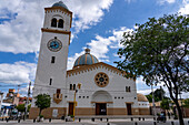 The exterior of the Church of Our Lady of the Rosary with its single bell tower with a clock. Monteros, Argentina.