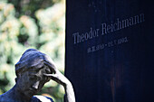 Berlin, Germany, July 27 2009, The intricate design of Theodor Reichmann\'s gravestone captures a moment of reflection in a serene Berlin cemetery.