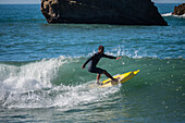 Surfers in Grande Plage beach of Biarritz, France