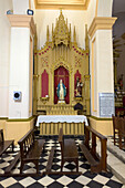 A side altar and altarpiece in the Cathedral of Our Lady of the Rosary in Cafayate, Salta Province, Argentina.