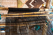 A wooden foot loom in a home weaving workshop in Seclantas, Argentina in the Calchaqui Valley.