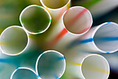 Vibrant, close-up view of various drinking straws showcasing their colors and details in an artistic composition.