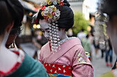 Group of women dressed as Maikos in the streets of Kyoto, Japan