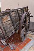 A vintage wooden cart for hauling wine barrels at the Museo de la Vid y el Vino or Museum of the Vine and the Wine in Cafayate, Argentina.