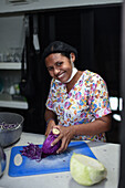 Portrait of young female cook cutting vegetables in Santa Marta, Colombia