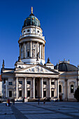 The iconic Deutscher Dom features stunning architecture and a grand dome in the heart of Berlin\'s Gendarmenmarkt square.