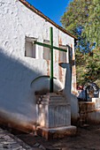 A wooden cross in front of the Church of Santa Rosa de Lima in Purmamarca, Argentina.