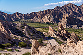 Route 40, an unpaved dirt road through the eroded landscape of the Angastaco Natural Monument in the Calchaqui Valley, Argentina.