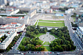 Aerial perspective captures the beauty of Marx-Engels-Forum park in Berlin, showcasing a miniature scene of greenery and city life.