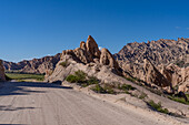 Route 40, an unpaved dirt road through the eroded landscape of the Angastaco Natural Monument in the Calchaqui Valley, Argentina.